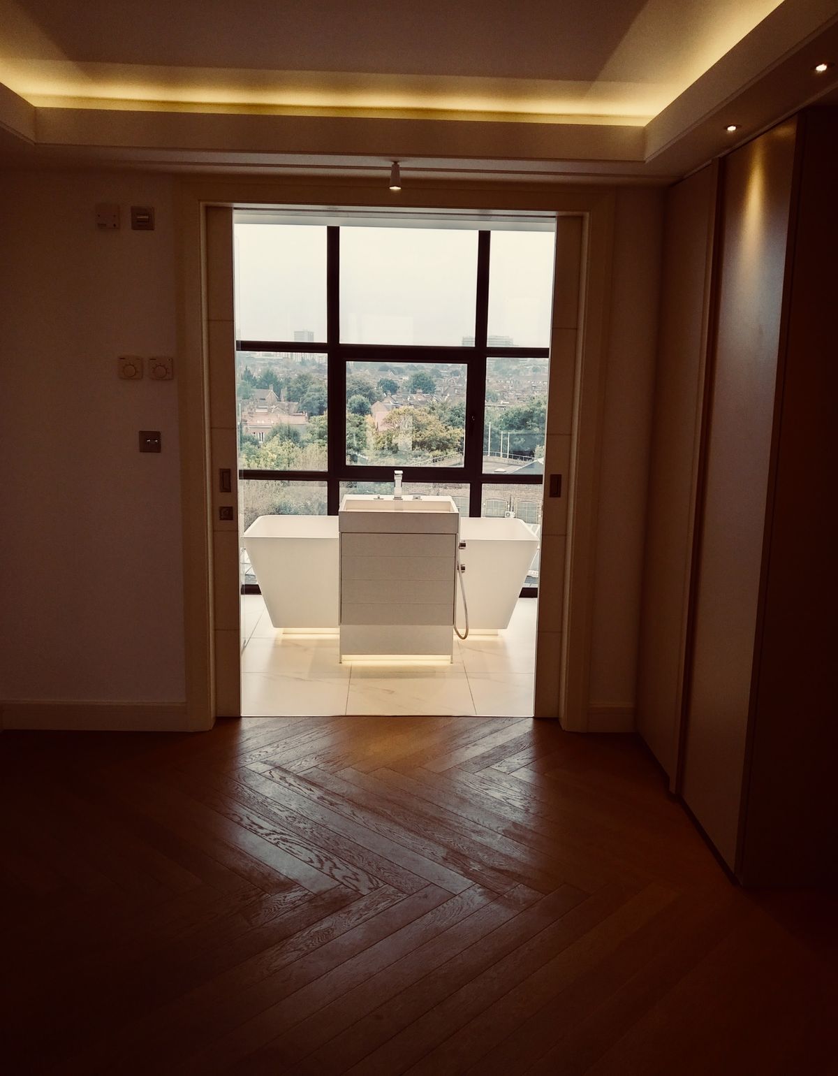 Walnut-panelled hallway with cove lighting