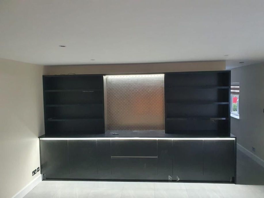 Dark kitchen run with backlit splashback